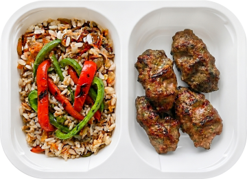 Grilled beef kofta with aromatic brown onion pilaf and veggies
